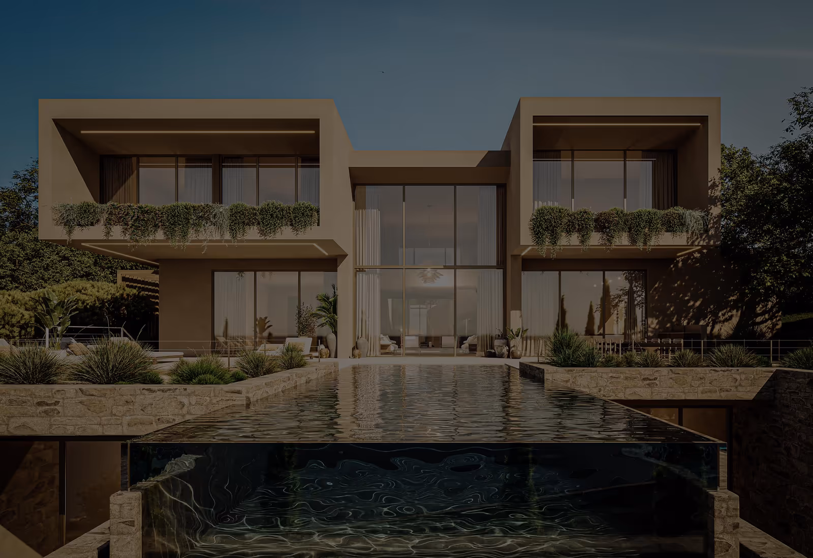 At dusk, a two-storey house in two framed volumes with planted balconies, large glazing and an infinity pool with a glass front.